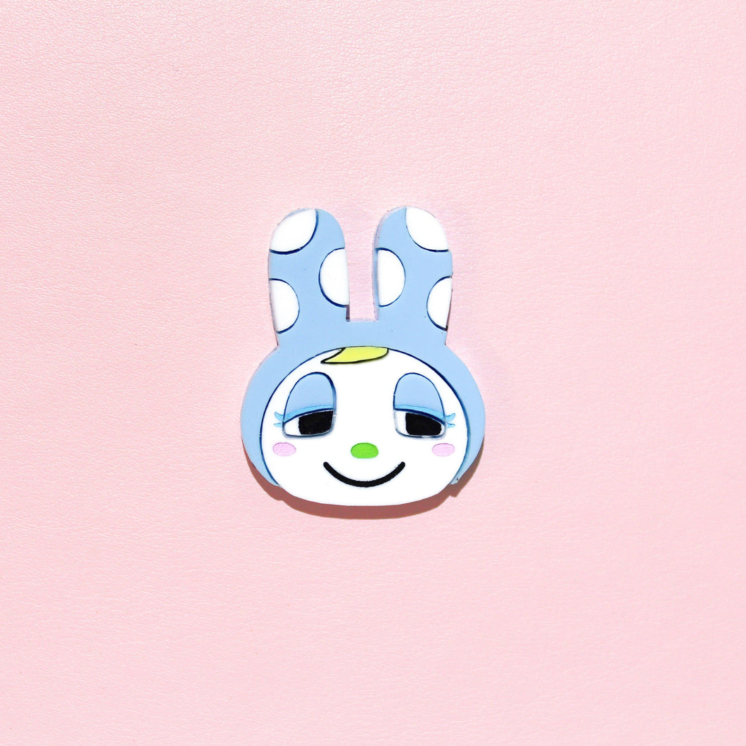 An acrylic brooch made of several intricate pieces of a cartoon rabbit. Or at least, she looks like a rabbit! Francine, older sister to Chrissy has blue eyeshadow, a lime green button nose and tuft of yellow hair sticking out from what is possibly a powder blue hat shaped like rabbit ears with white polka dots.