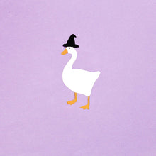 Load image into Gallery viewer, A cute lil brooch of a goose wearing a tiny black witch hat. Made from acrylic plastic, in front of a purple background. The goose is plain white, with an orange beak and matching orange legs.
