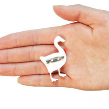Load image into Gallery viewer, Close up of the reverse side of a goose brooch. A silver clasp is glued horizontally to the centre. The brooch is in the middle of a hand hovering over a white background.

