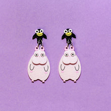 Load image into Gallery viewer, A pair of dangly earrings made of two parts. The first, a black bird and a yellow beak. Hanging below the bird, attached by two silver coloured rings is a big pink, mouse with pink ears and claws.
