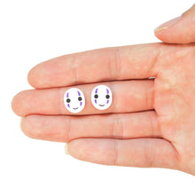 Load image into Gallery viewer, A close up of a hand facing up. Resting on the middle finger are two white ovals with little smiling faces and purple streaks above and below each eye. Behind the hand is a white background.
